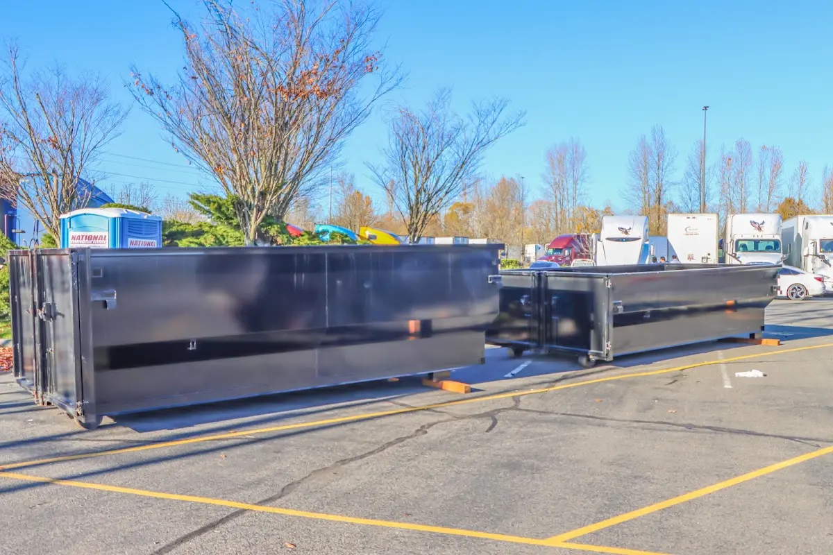 Professional dumpster rental service with roll-off container on residential driveway in Lihue